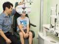 A Specsavers optometrist conducting an eye test on a child. Picture supplied