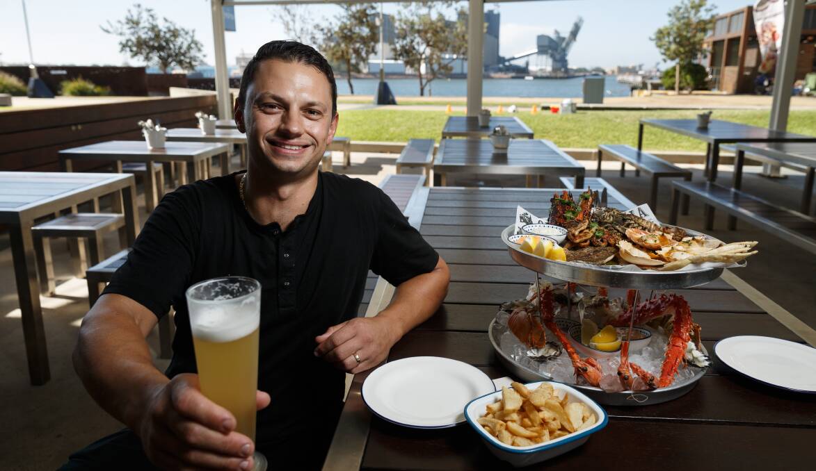 Summer Feast: The Kingfish owner Garry Risteski with their Grilled Seafood Platter. Picture: Max Mason-Hubers