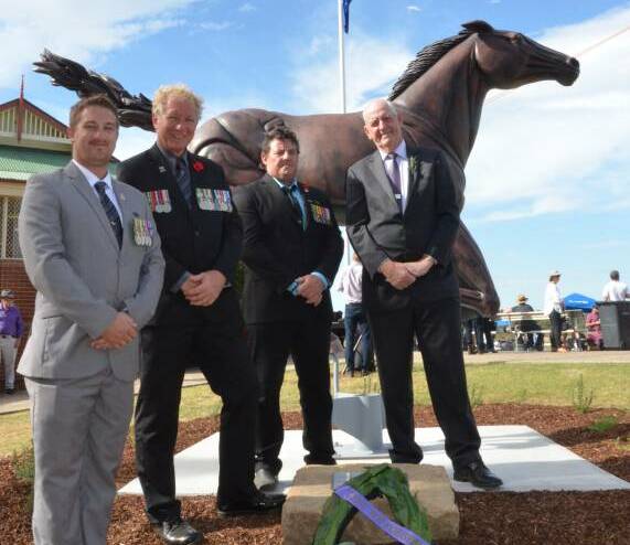 TRIBUTE: Stewart Sherman, Dan Jeffery and Craig Blue, from Soldier On, and Newcastle Jockey Club chairman Geoff Barnett after the war horse statue was unveiled at Cessnock Racecourse on Anzac Day. Picture: Krystal Sellars