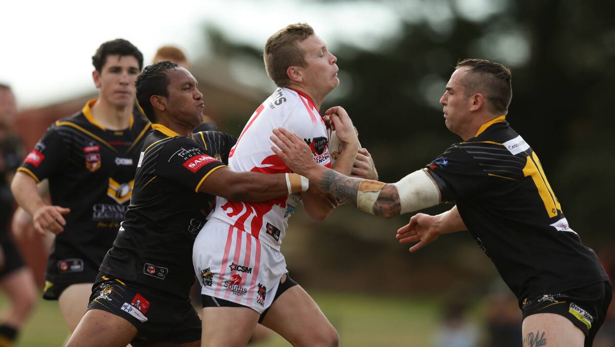 COOL HEAD: South Newcastle halfback Jason Keelan is met by the Cessnock defence. Picture: Jonathan Carroll