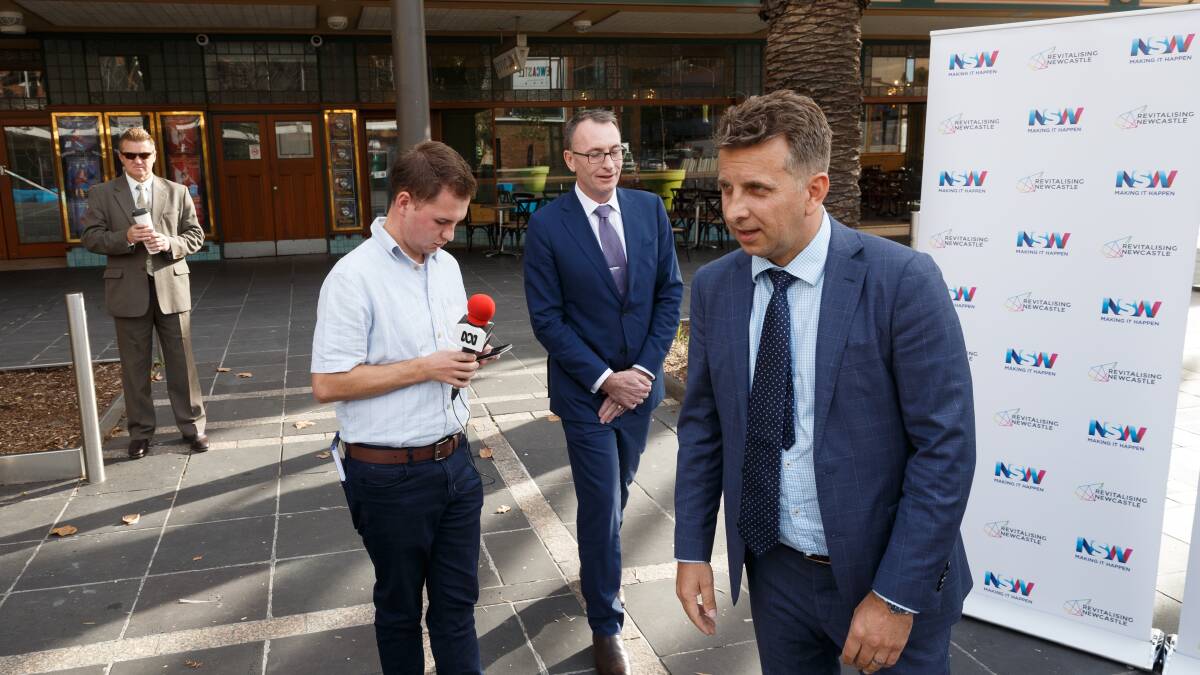 SPRAY: Transport Minister Andrew Constance, front, with Revitalising Newcastle boss Michael Cassel in Newcastle on Thursday. PICTURE: Max Mason-Hubers