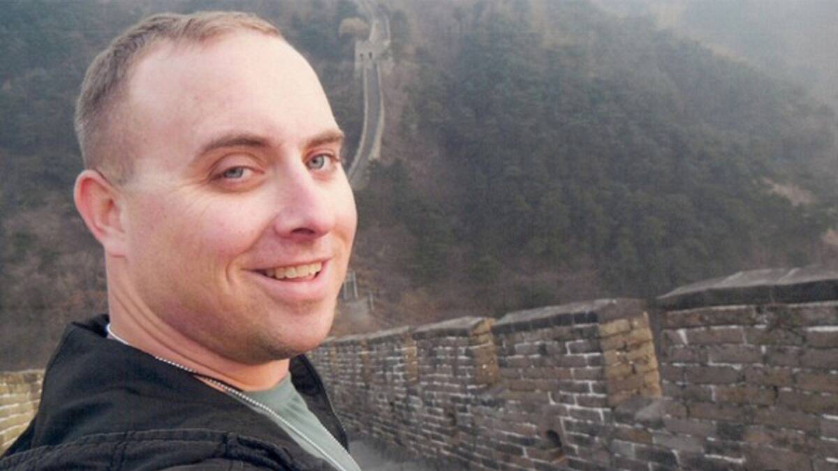 WANDERLUST: Stephen Rowe, 33, hopes to complete 65 Contiki tours by the time he's 35. He's pictured here on the Great Wall.