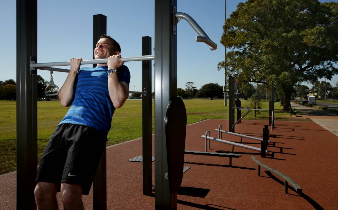 CHIN UP: Maitland Councillor Ben Whiting testing the new gym equipment at Maitland Park ... “the plan is certainly turning the park into a city showpiece.” Picture: Simone De Peak.