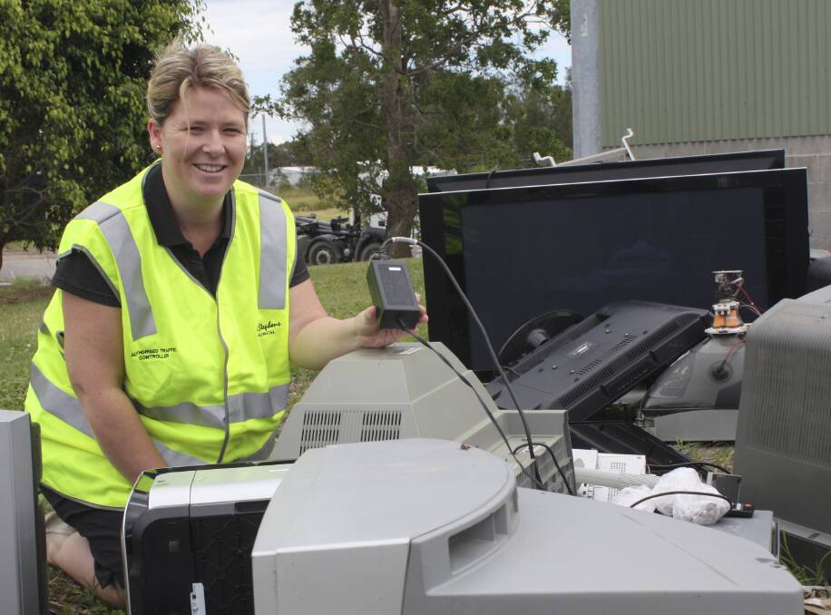 DISCARDED: Emma Penfold from Port Stephens Council with some of the e-waste that is dumped at the Salamander waste depot. Picture: Charles Elias