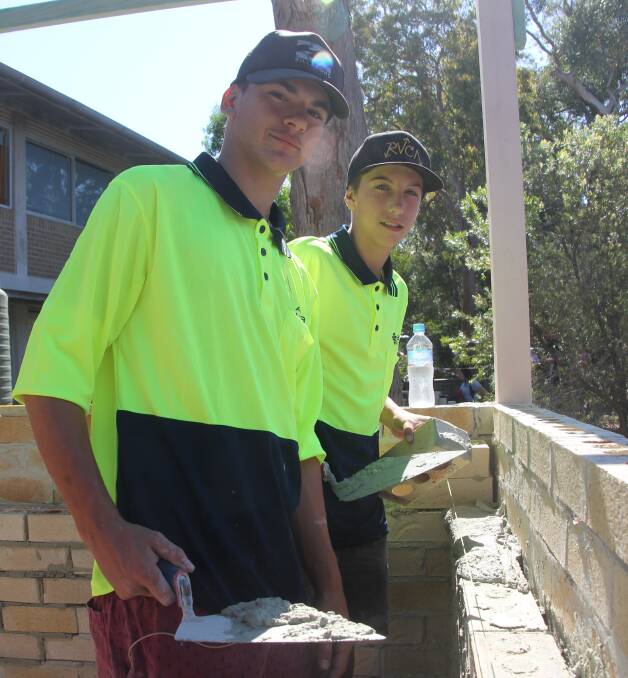 HANDS ON: Students Ammon Hall (left) and Joel Hughes working on the barbecue at Tomaree High School. Picture: Keith Campbell