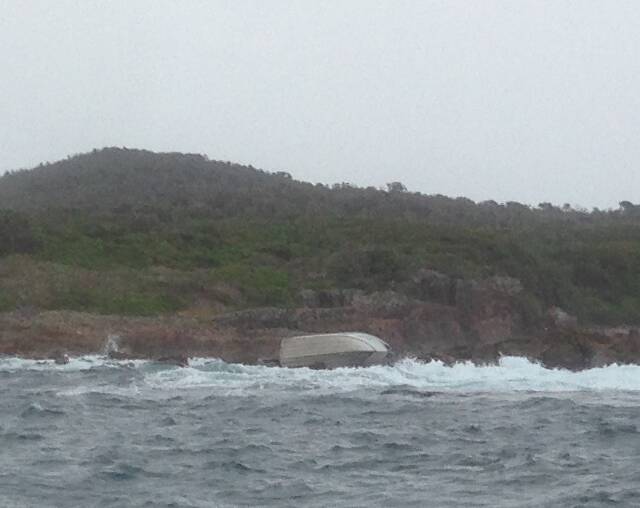 RUN AGROUND: The stricken vessel on the rocks at Fingal Island on Sunday. Picture: Supplied