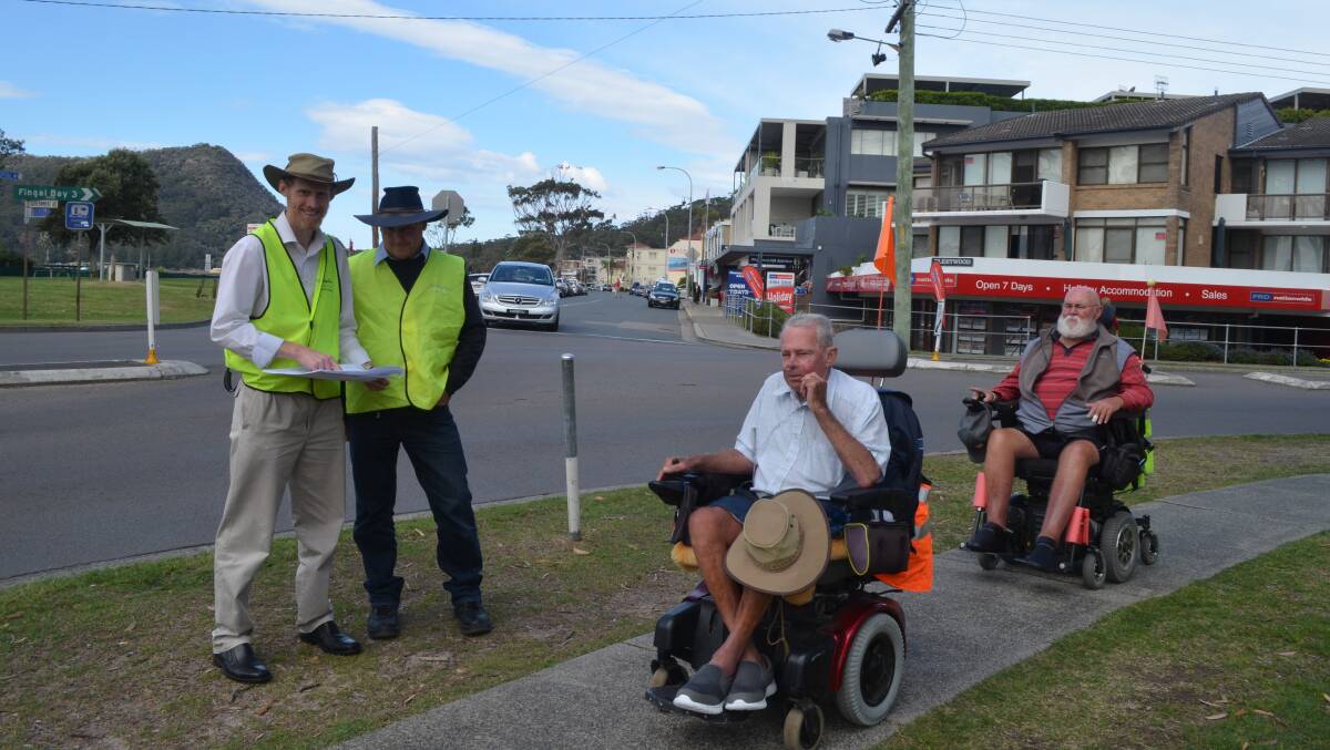 WHEELS IN MOTION: Rick Mackenzie and Graham Orr from the council's projects team consulted Barry Roberts and Peter Drummond among others on the Shoal Bay intersection. Picture: Sam Norris