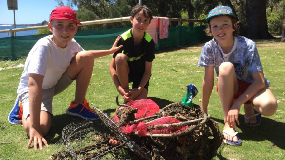 THAT'S A HAUL: Oscar Bell, Samuel Finn and Troy Voyzey with rubbish collected from Nelson Bay breakwall. Picture: Supplied