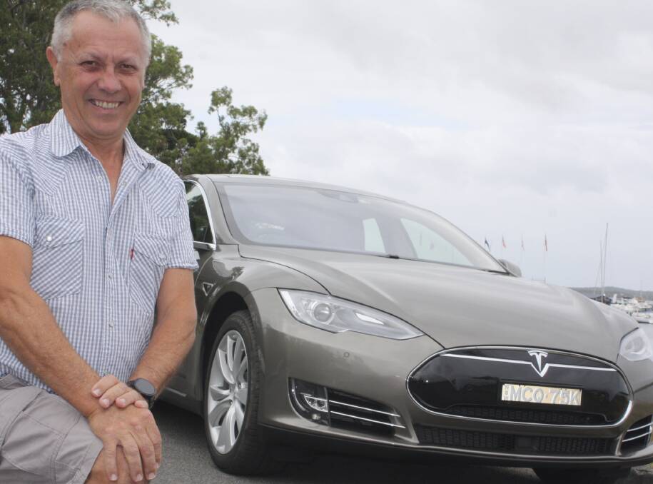 EASY SMILES: Paul McQuarrie with his $170,000 electric Tesla. From stationary to 100 kmh in 4.4 seconds, and zero tail-pipe emissions - you'd smile too. Picture: Charles Elias 