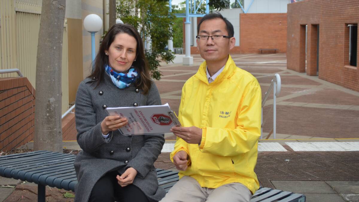 SORROW: Car tour organiser Gina Shakespeare with a persecuted member of the Falun Gong, Zhansheng Liu. Picture: Sam Norris 