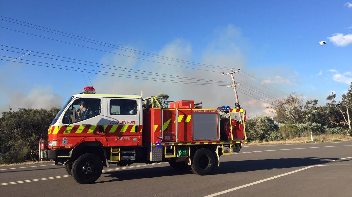 WATCH AND ACT: Fire fighters are on the scene of the Fenninghams Island Road fire at Anna Bay, which is burning parallel to Nelson Bay Road toward Port Stephens Drive. Picture: Ellie-Marie Watts