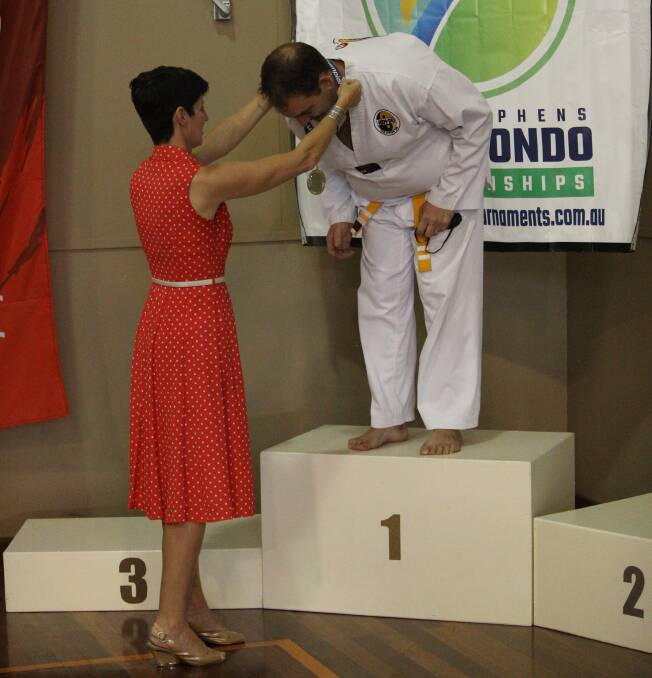 WINNER: Port Stephens MP Kate Washington presenting medals at the recent Port Stephens Taekwondo Championships. Picture: Supplied