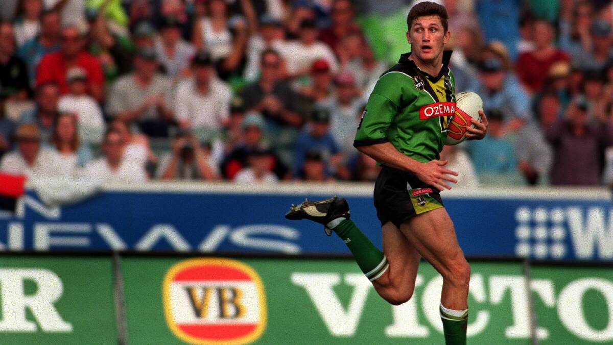 RUNAWAY: Brett Mullins strides out for a try against the Sharks in April 2000.