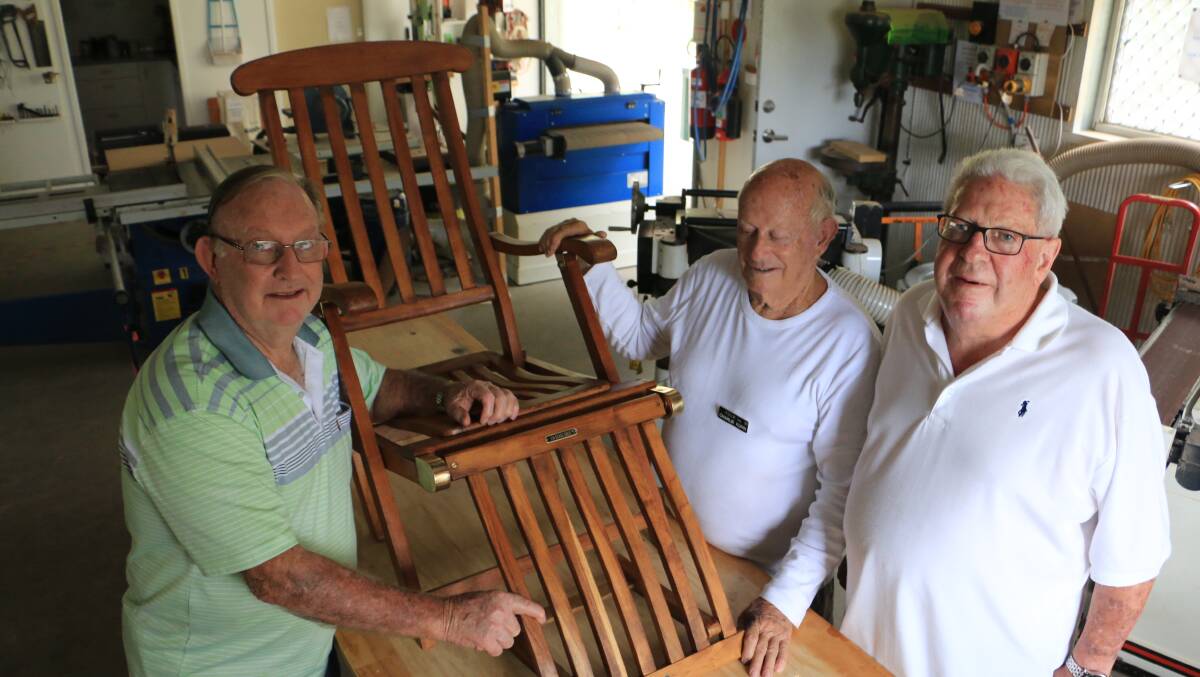 TICKLED PINK: The Woodies workshop manager Geoff McClelland and fellow member Charlie Kuhn have restored two deck chairs for John Flannagan. Picture: Sam Norris
