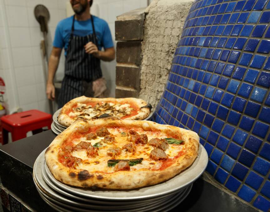 MAIN ATTRACTION: Pizzas beside the wood-fired oven.