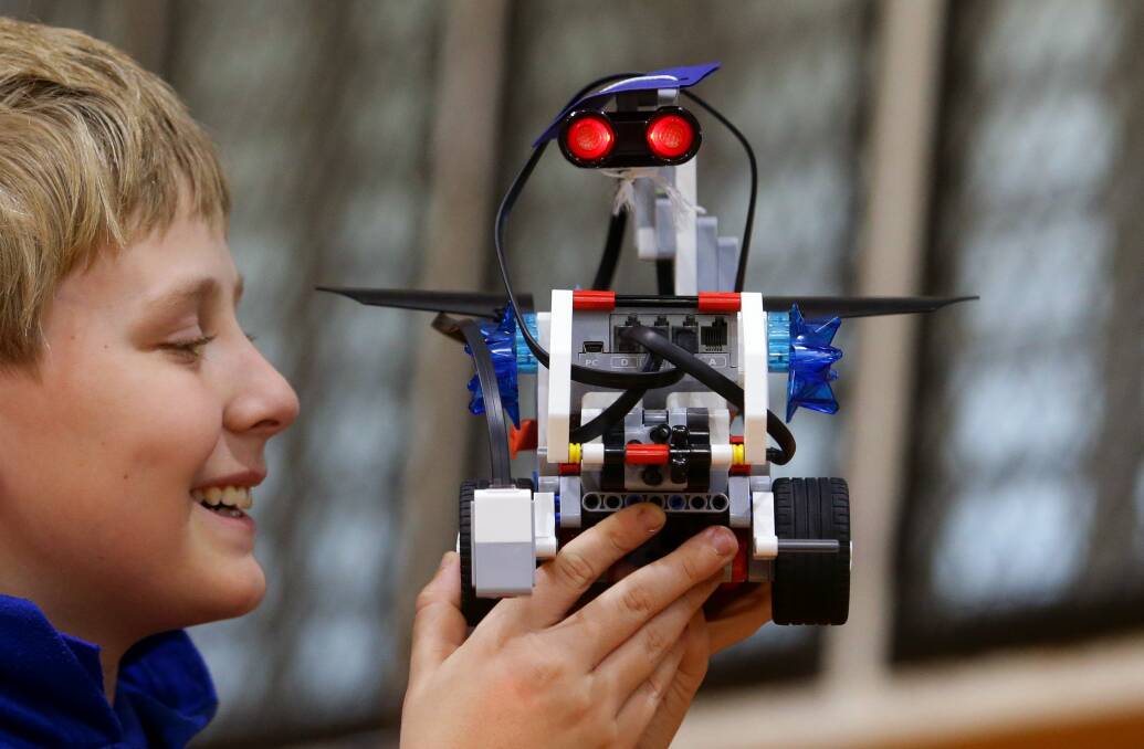 Eyes on the prize: Nicholas Bendeich from West Wallsend Public with his robot at the Robocup Junior at the Newcastle University Forum. Picture: Jonathan Carroll