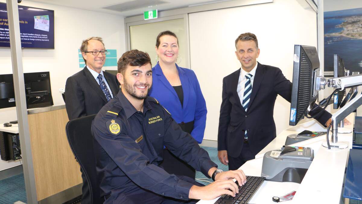 TERMINAL VISIT: Airport CEO Peter Cock, Liberal candidate Jaimie Abbott and Transport Minister Andrew Constance watch a border security representative at work during their facility visit on Tuesday.