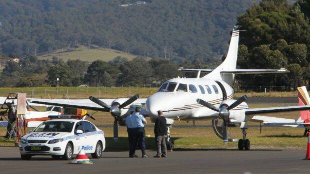 Police examine the twin-engine turbo-prop Swearingen Merlin 3 eight-seater at Illawarra Regional Airport on July 9, 2014.  Photo: Kirk Gilmour
