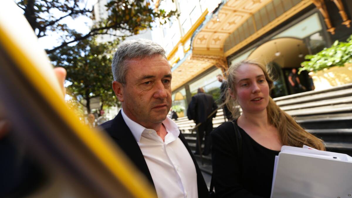 ACCUSED: Former winemaker David James attempting to avoid the media outside court in Sydney. Picture: Jonathan Carroll