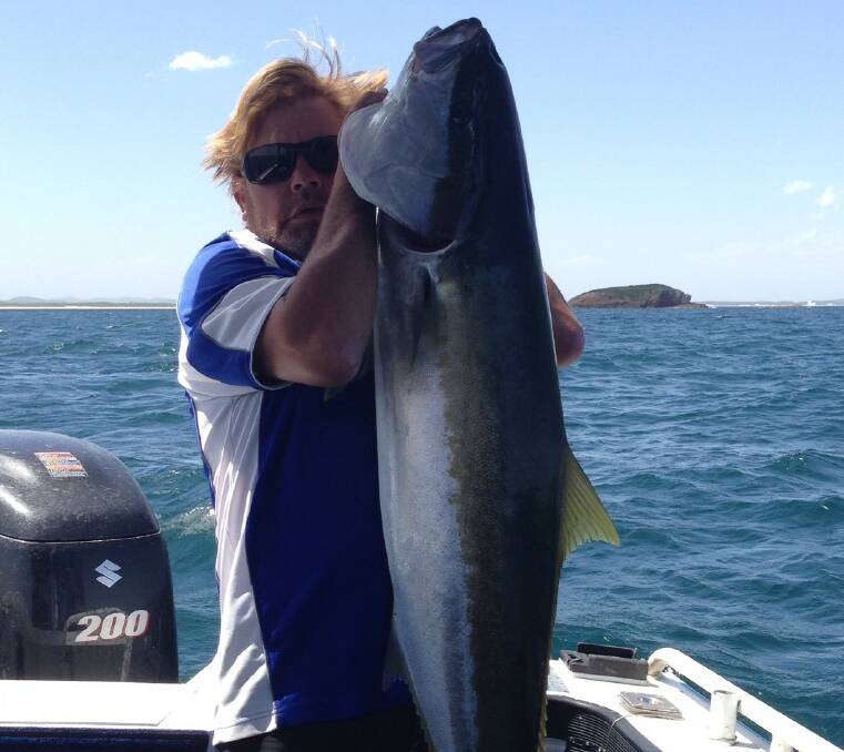 BIG LAND: Ben Lamb with his monster 28-kilogram kingfish. It took him 30 minutes to haul it in.