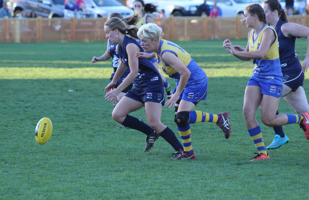 HARD-FOUGHT: Emma Chester, right, tussles with a Newcastle City player for the ball in the women's Black Diamond AFL grand final on Saturday.