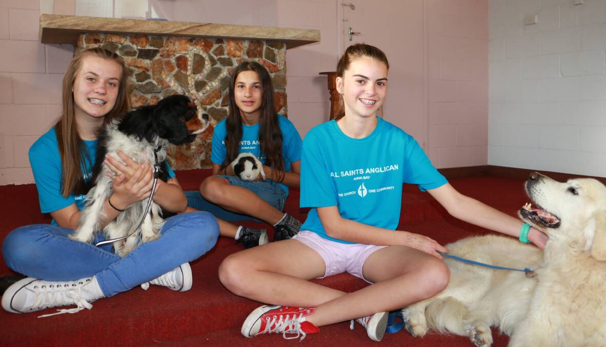 ALL ANIMALS WELCOME: Molly Torr, 13, with Charlie, Beth Govan, 11, with Nelson the guinea pig, and Ella Kearton, 13, with Ned at the Peace Lutheran Church in Anna Bay. Picture: Ellie-Marie Watts
