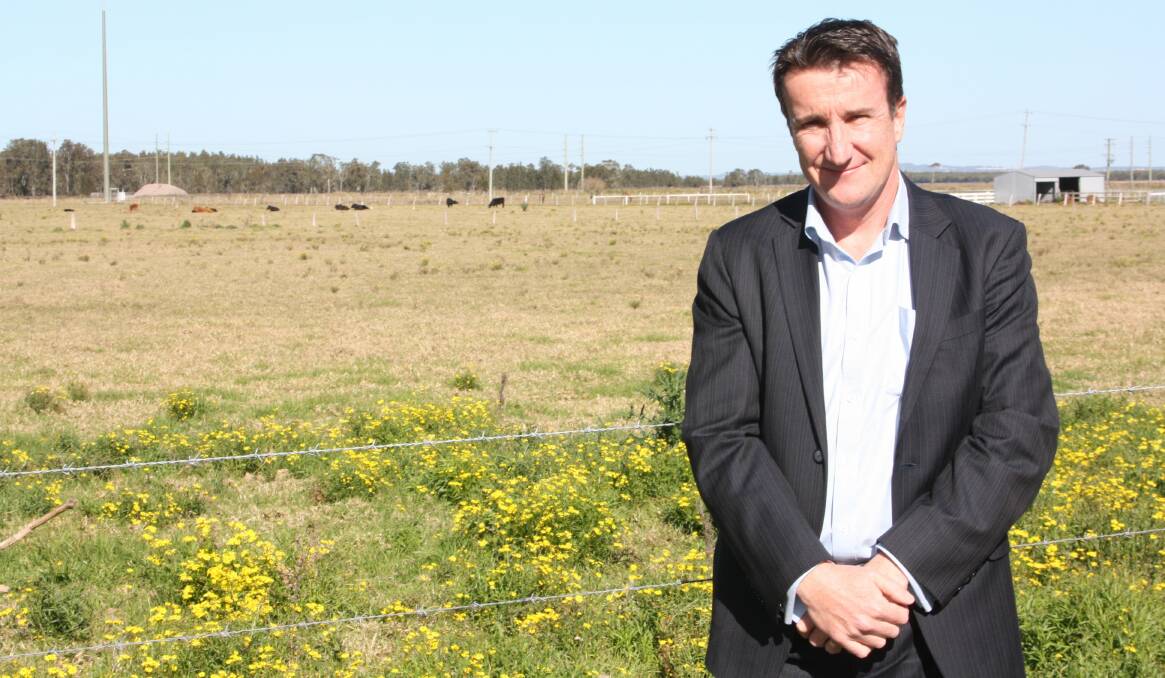 UNTAPPED POTENTIAL: Developer Edward Crawford, pictured in 2012, standing in front of land at Williamtown that has been earmarked for development. Picture: Stephen Wark