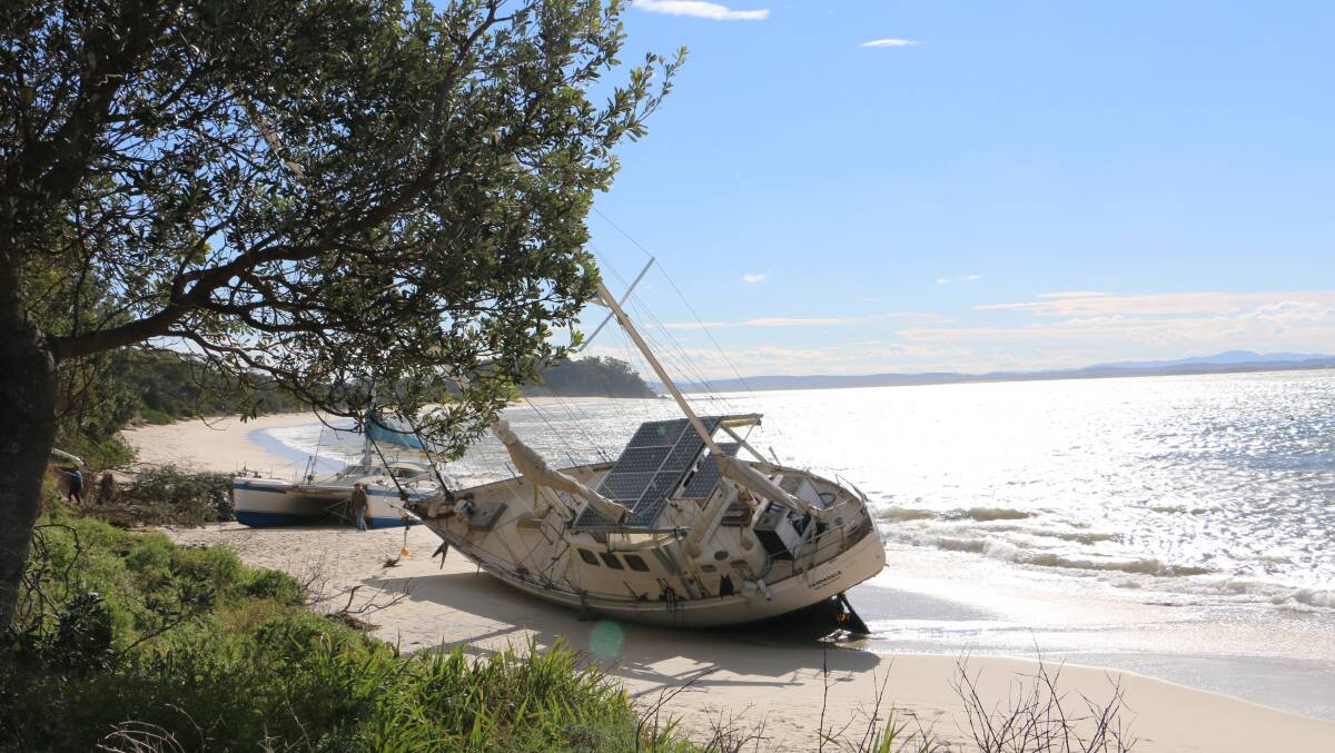 Two vessels washed up on Shoal Bay Beach during the weekend's east coast low weather event proved to be an unlikely tourist attraction on Monday. Picture: Ellie-Marie Watts