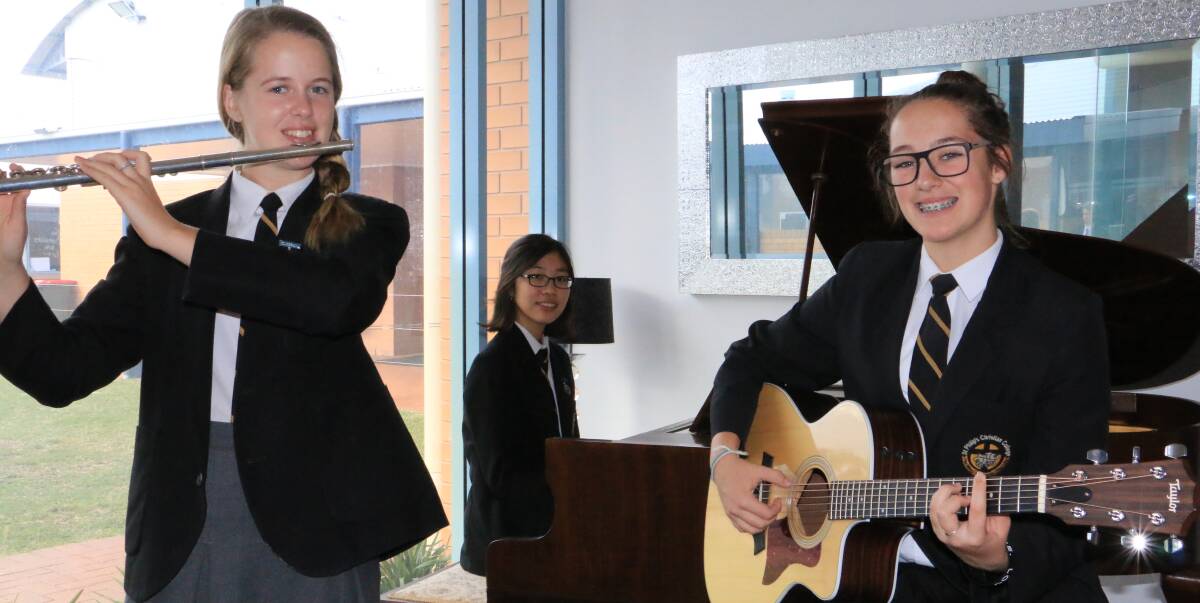 IN TUNE: St Philip's Christian College music students Grace Gayden, 17, Grace Kim, 17, and Juanita Porteiro, 14. The school will have students in the carols. Picture: Ellie-Marie Watts