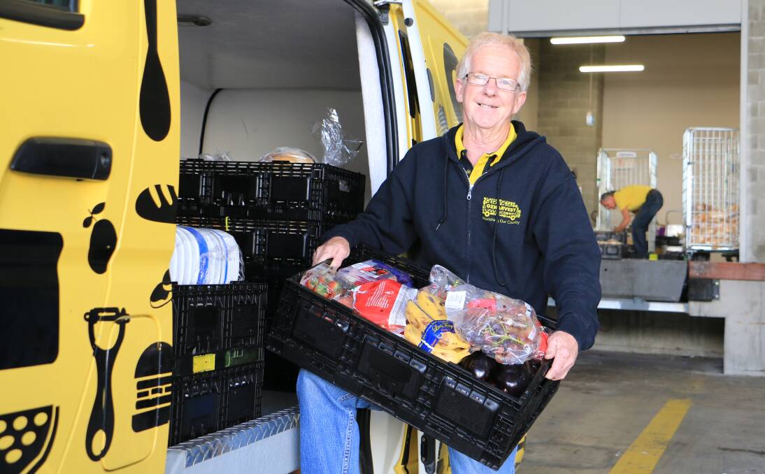 FOOD FOR THOUGHT: Neil Furner, an OzHarvest Newcastle driver, collecting food from Woolworths at Nelson Bay. The charity will service Salamander Bay as well. Picture: Ellie-Marie Watts