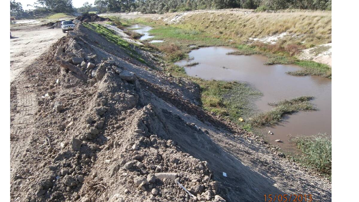 Dumped: Stockpiles of waste up to eight metres high were found near and in waterways at Macka's Sand, Salt Ash, in 2013. The company has been charged with using the site as an unlawful waste dump.   