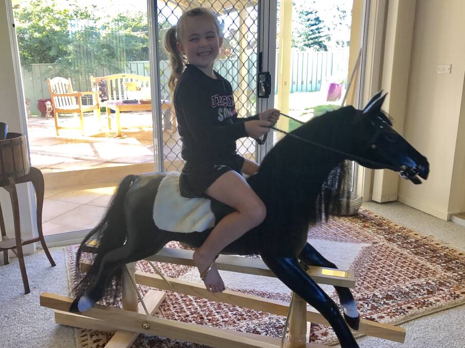 OVER THE MOON: Lacey McCourt with the winning rocking horse.