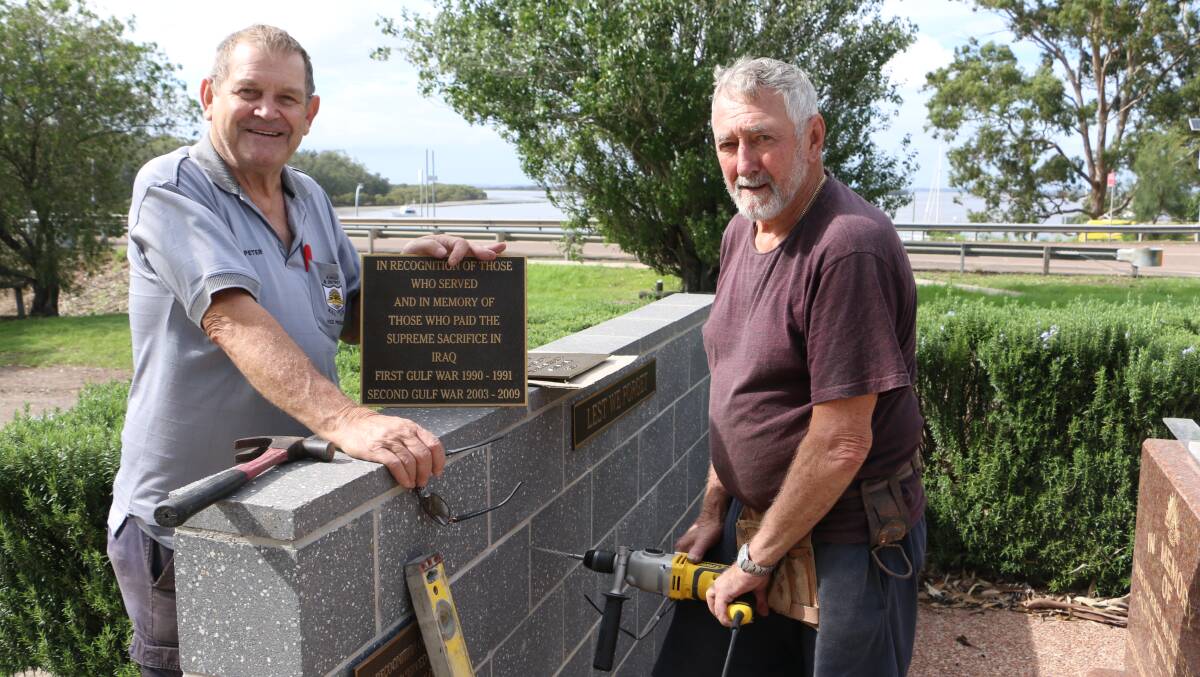 ON THE TOOLS: Karuah RSL Sub-Branch president Peter Fidden with RSL club director Peter Aylife fitting the new plaques. Picture: Ellie-Marie Watts