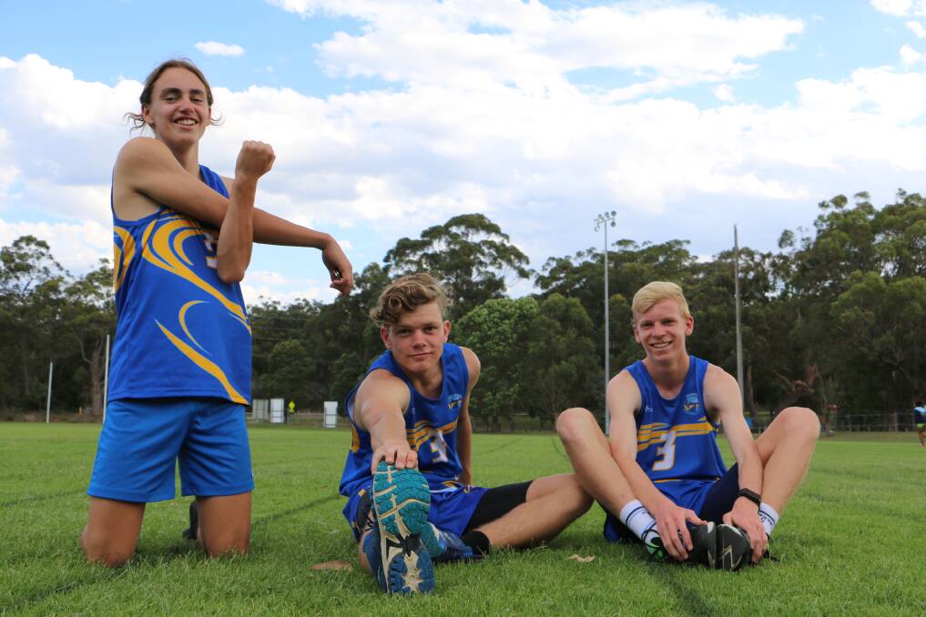Ben Esquilant, Cooper Luff, Aidan Moulder, all 14, warming up before athletics at Tomaree Sports Complex on Monday.