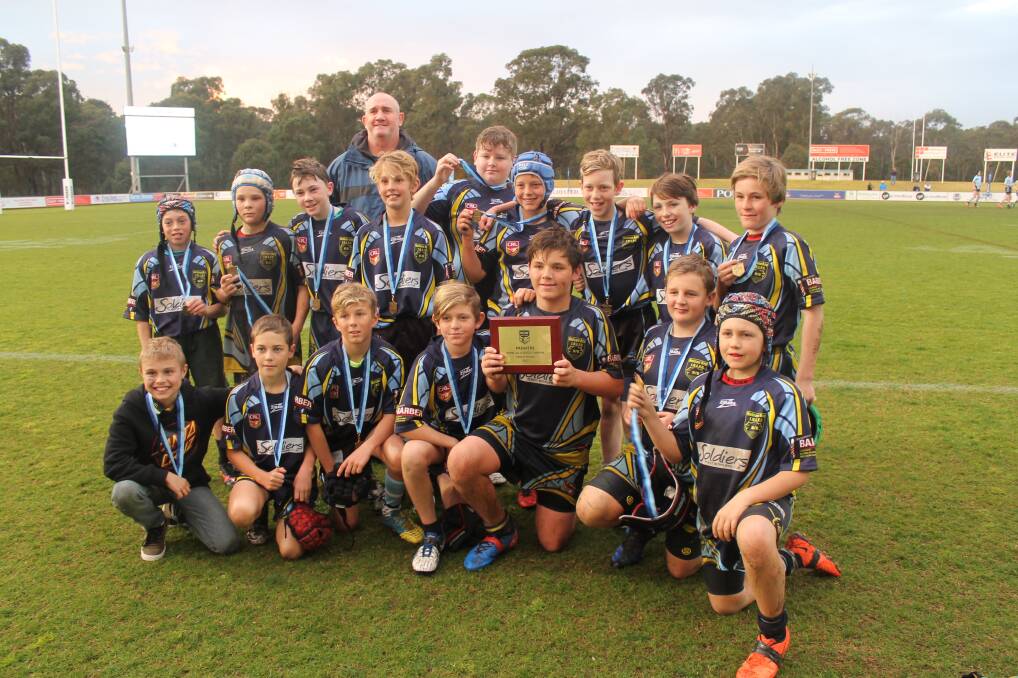 GLORY: St Michael's Primary School won the Open Primary B Division at the NSW Rugby League All Schools Carnival. The team is pictured with coach Craig Read. Picture: Supplied