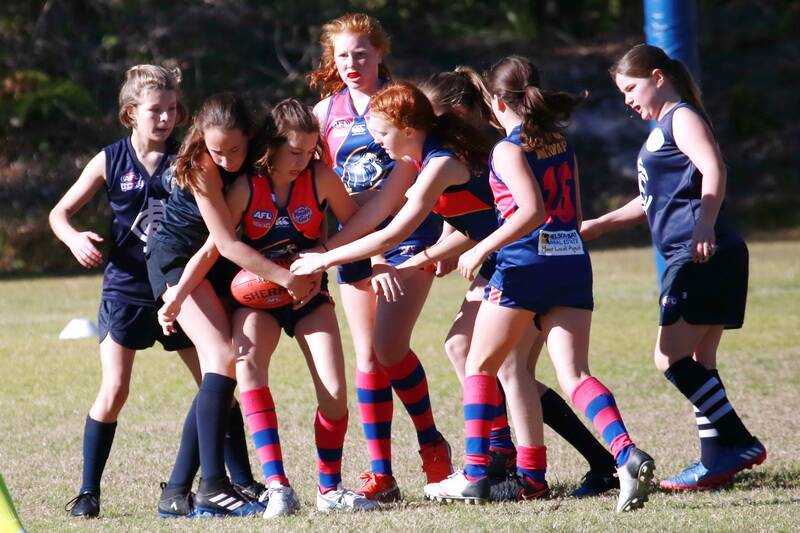 IN IT TO WIN IT: Nelson Bay Marlins under-12 girls team (in blue) in action. It is the first year the club has put together a girls team for the age group. Many team members are new to AFL.