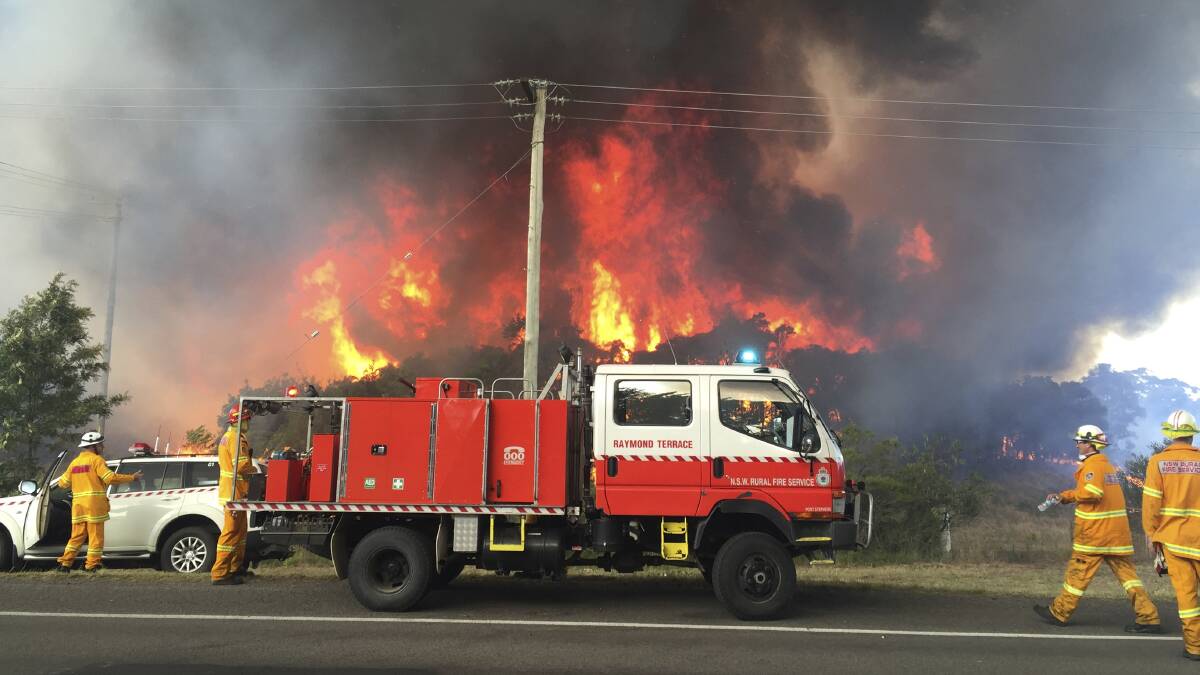 RFS firefighters battling a fire at Williamtown in December 2016. Picture: Max Mason-Hubers