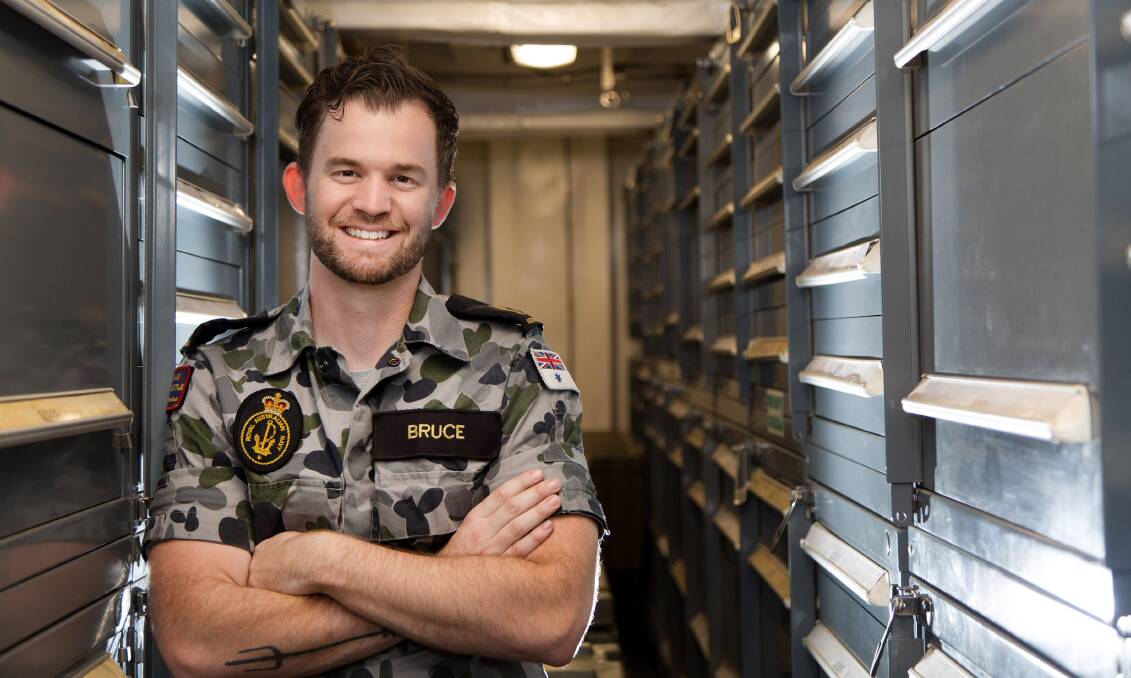ON DUTY: Able Seaman Matthew Bruce, of Nelson Bay, stands in the naval stores compartment of HMAS Newcastle while on Operation Manitou in the Middle East region. Picture: Nicolas Gonzalez 