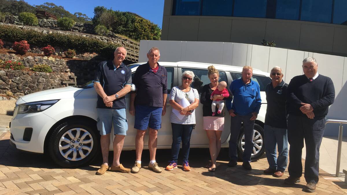 JOY: Con Moores, Russ Crompton, Julie Burns, Kasie Sargeant, Barry Gamer, Allan Barnes and Dean McCarthy at Nelson Bay Bowling Club with the car.