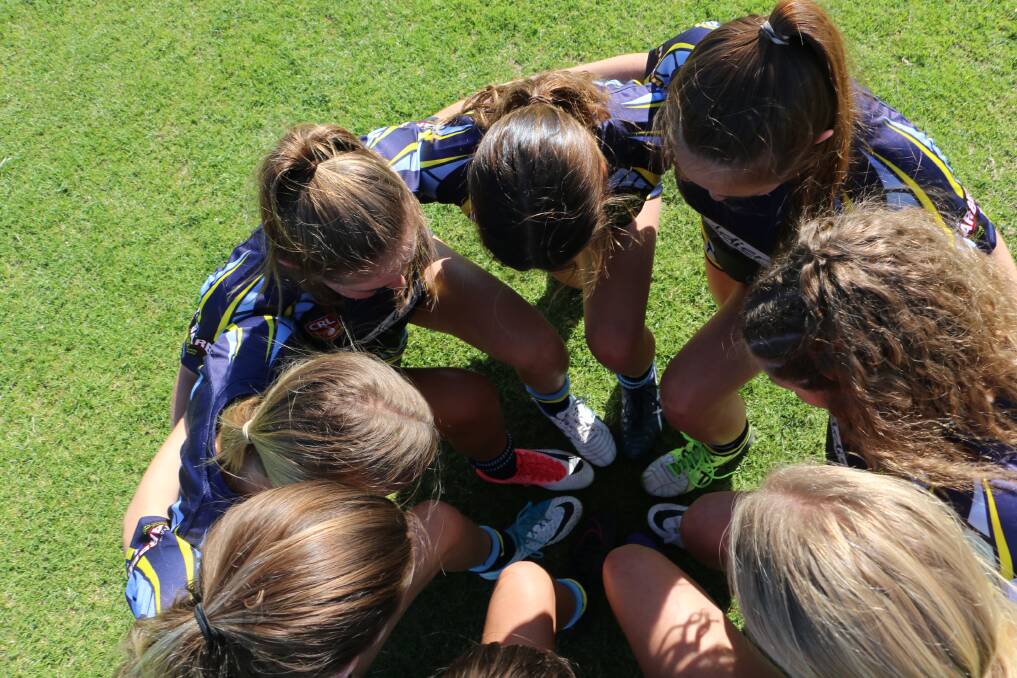 The girls in a huddle at Salamander Sports Complex. Picture: Ellie-Marie Watts