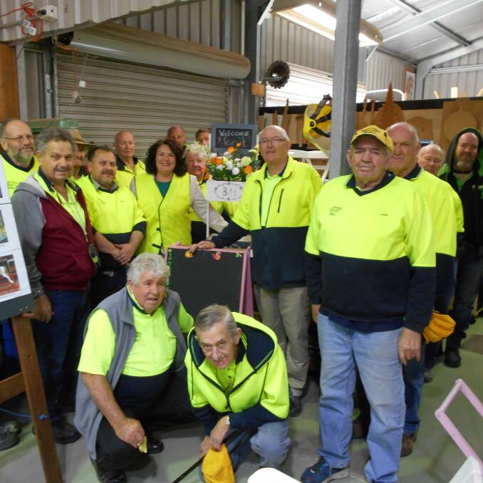 HARD AT IT: Paterson MP Meryl Swanson (middle right) with members of the Salamander Bay Men's Shed. The shed has been successful in a grant.