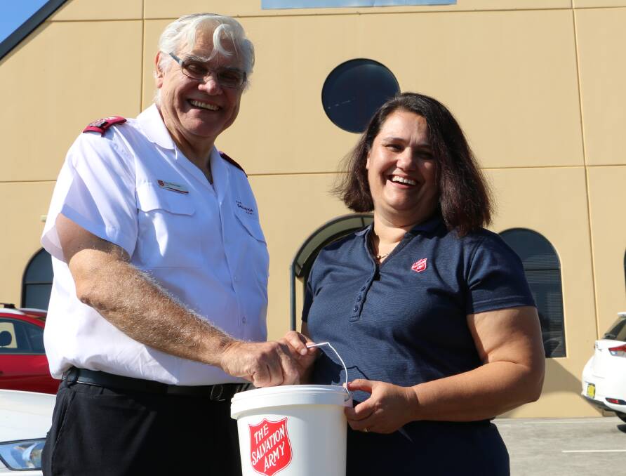 FOR CHANGE: Envoy Ron Petterson and Salvation Army Lieutenant Tracey Isles with the familiar Red Shield Appeal bucket outside the Raymond Terrace church. 