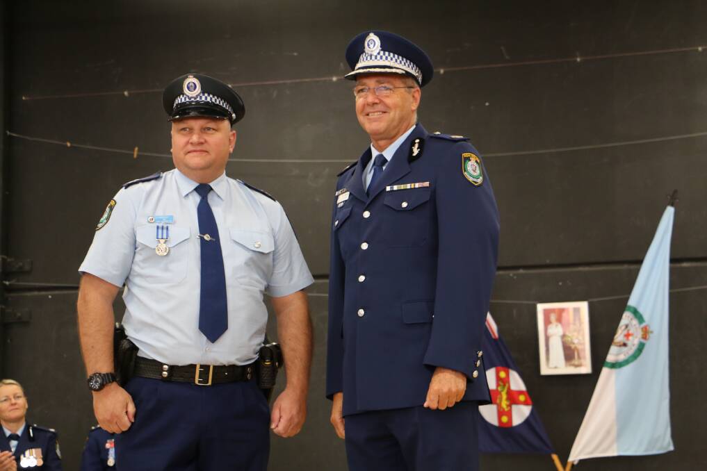 Senior Constable Jason Wright with Assistant Commissioner Max Mitchell APM.