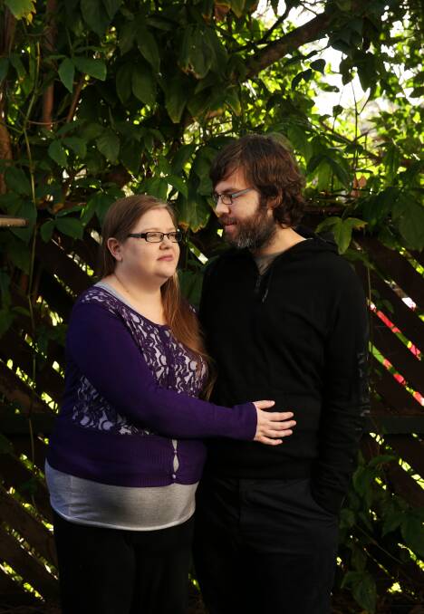 MUTUAL SUPPORT: Kimberly and Peter Cross, who met while being treated for schizophrenia, in the courtyard of their home. Picture: Simone De Peak