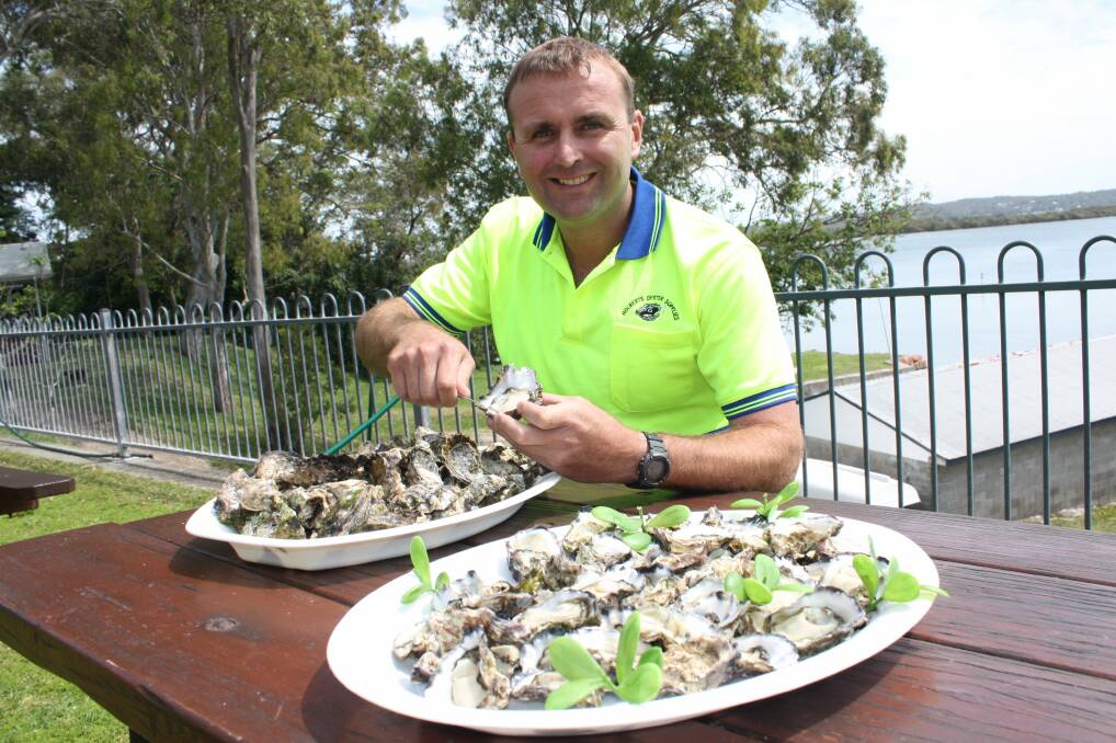 GOURMET: Guy Holbert, at Holberts Oysters Salamander Bay, shucking the delicacies. Picture: Stephen Wark