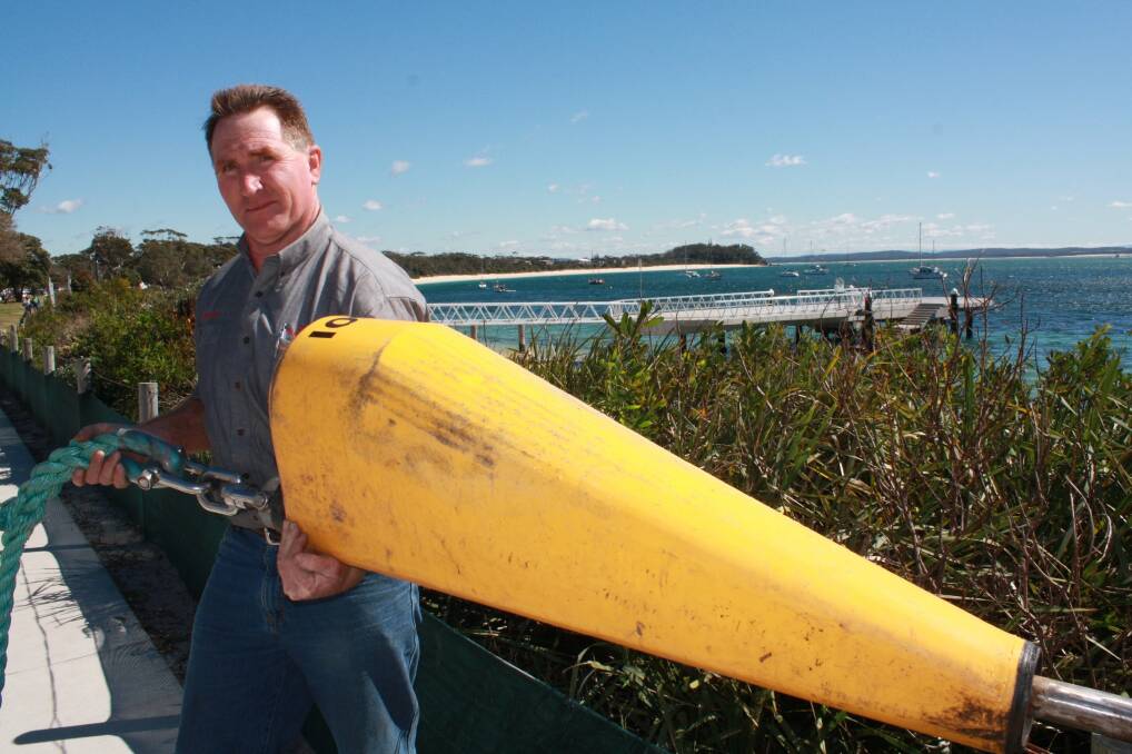 LOCAL SUCCESS: Des Maslen with his award-winning mooring at Shoal Bay. Picture: Stephen Wark