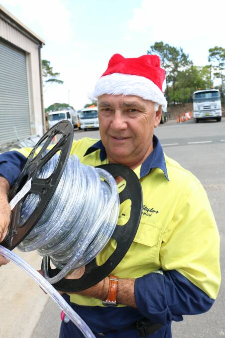 NOT LIGHT WORK: Kevin Mills, from Port Stephens Council, with some of the new Christmas tree lights. Picture: Stephen Wark