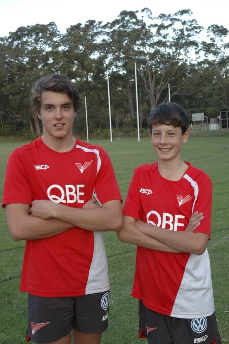 EXCITED: Luke Rymer, 15, and Noah Connick, 12, in their Swans academy jumpers at Nelson Bay's Dick Burwell Oval. Picture: Charles Elias