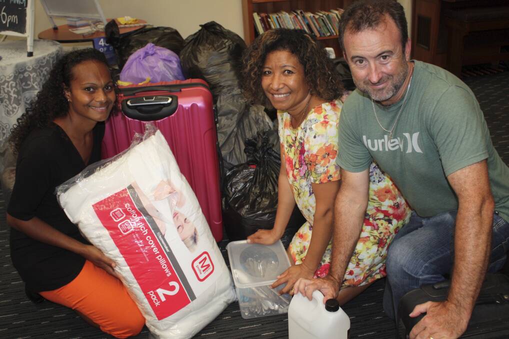 AID: Pastor Bill Brill with wife Esther and supporter Abi Blake with some of the goods to be shipped to Vanuatu. Picture: Charles Elias
