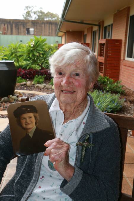 PROUD: Patricia Mason at Opal Raymond Terrace Gardens with a picture of herself as a 19-year-old WAAAF. Picture: Stephen Wark